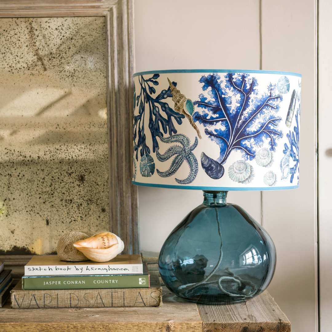 Lifestyle shot of beautiful lampshade with clear petrol blue base. 