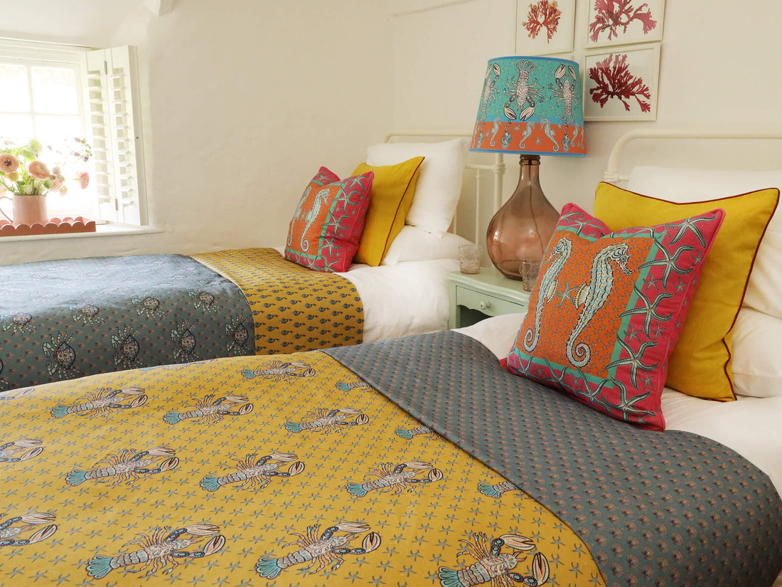 Mid shot of bedroom dressed in Byron coastal luxury fabric and cushions