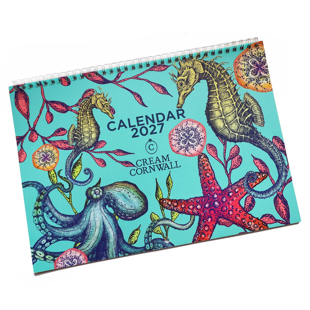 2027 calendar flat lay on white background .The cover is in bright turquoise with brightly coloured sea creatures on.