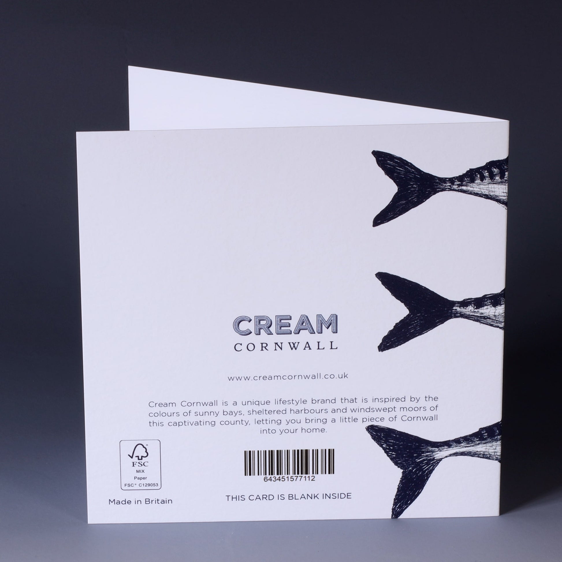 back of greeting card with navy illustration of 3 mackerel without tails on a white background