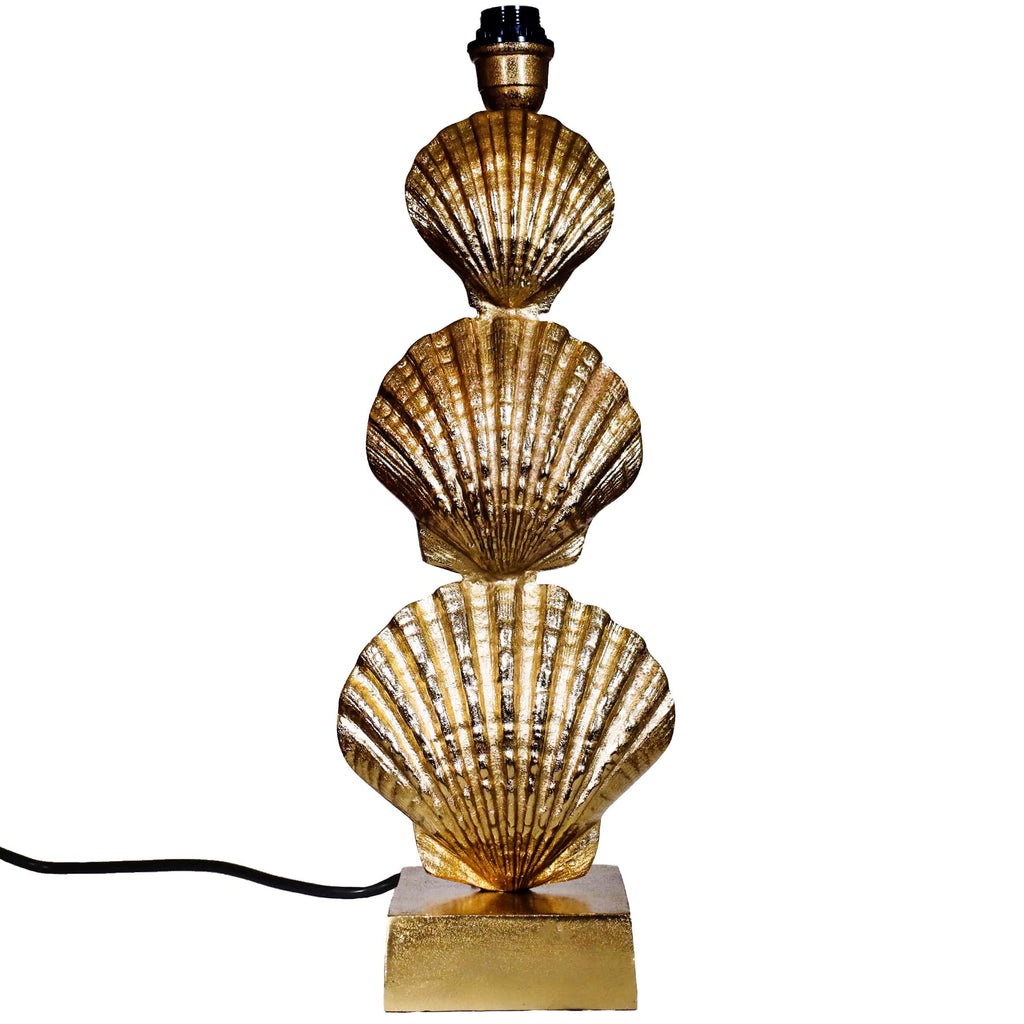 Gold shell-shaped table lamp on a white background