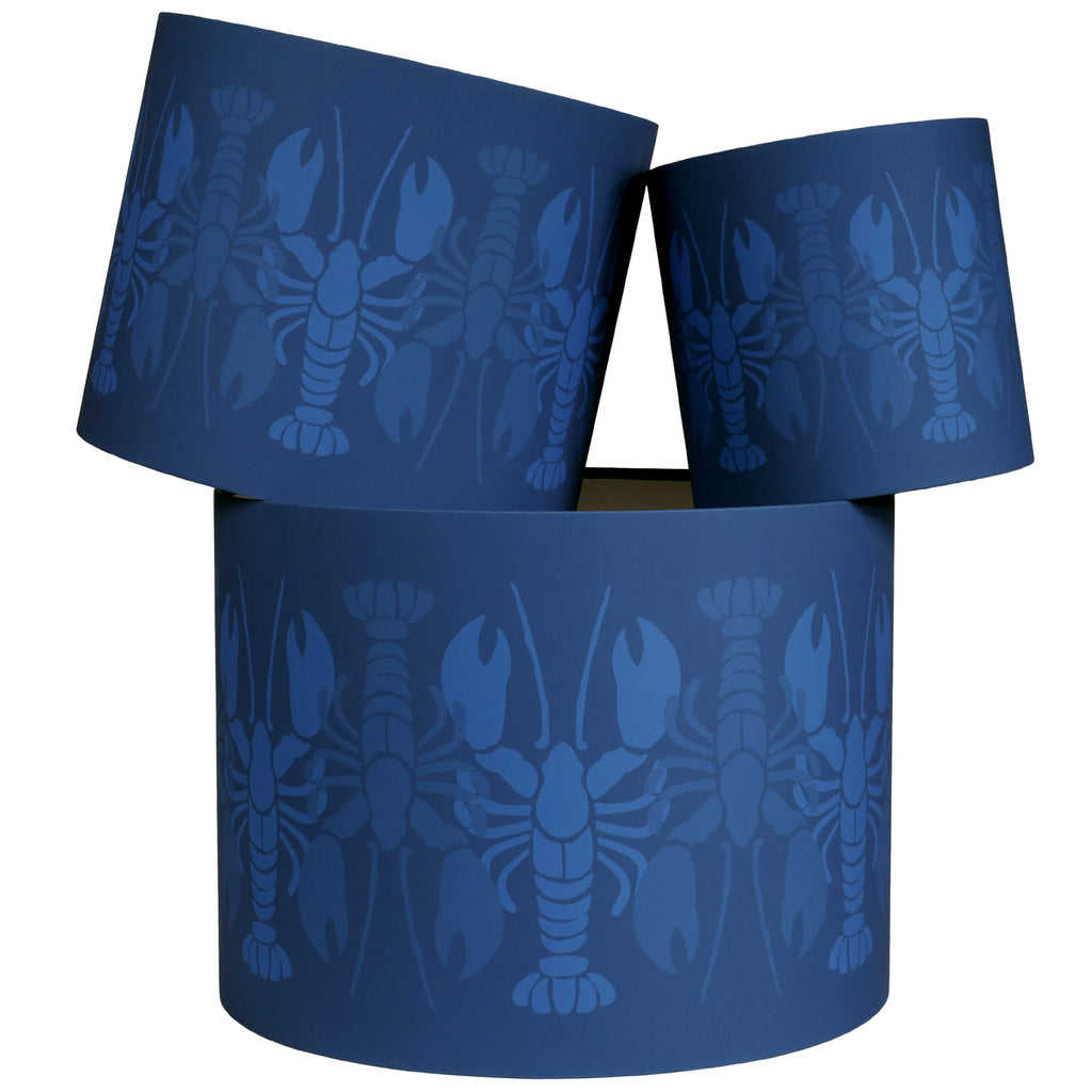 Blue cylindrical lampshades with lobster pattern on a white background