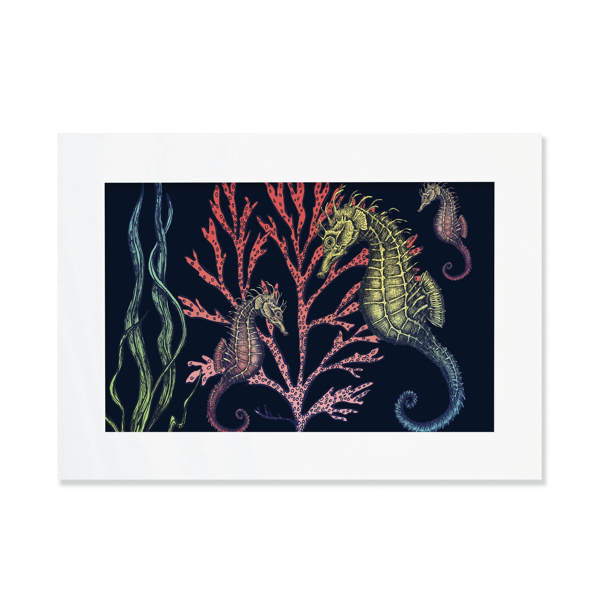 An A3 framed art print featuring an intricate underwater illustration of three seahorses with detailed, textured bodies in shades of green, gold, and red. They are set against a dark navy background, swimming among vibrant coral in pink and red tones, alongside flowing strands of seaweed. The illustration is rich in detail, creating a whimsical and nature-inspired ocean scene.