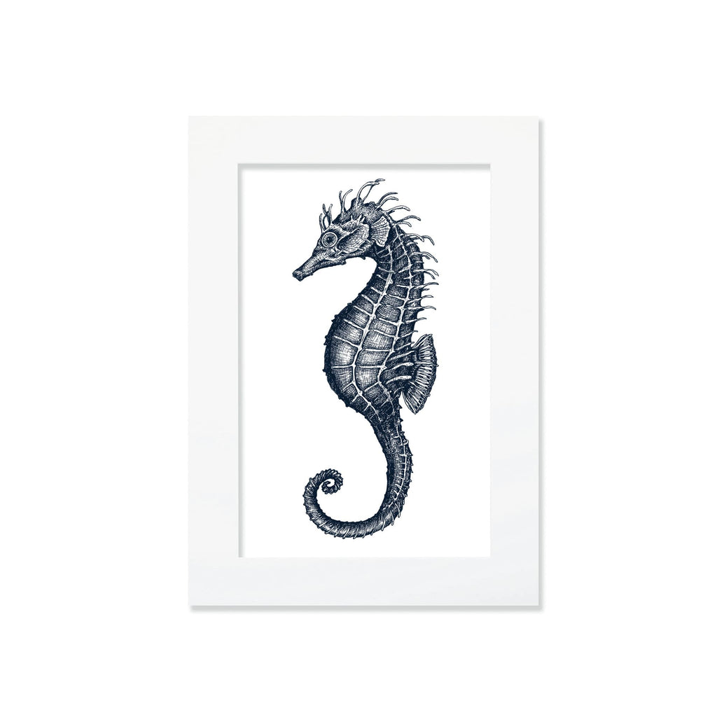 An A4 mounted blue-and-white illustration of a seahorse, intricately detailed with fine lines and shading, set against a white background in a white mount.