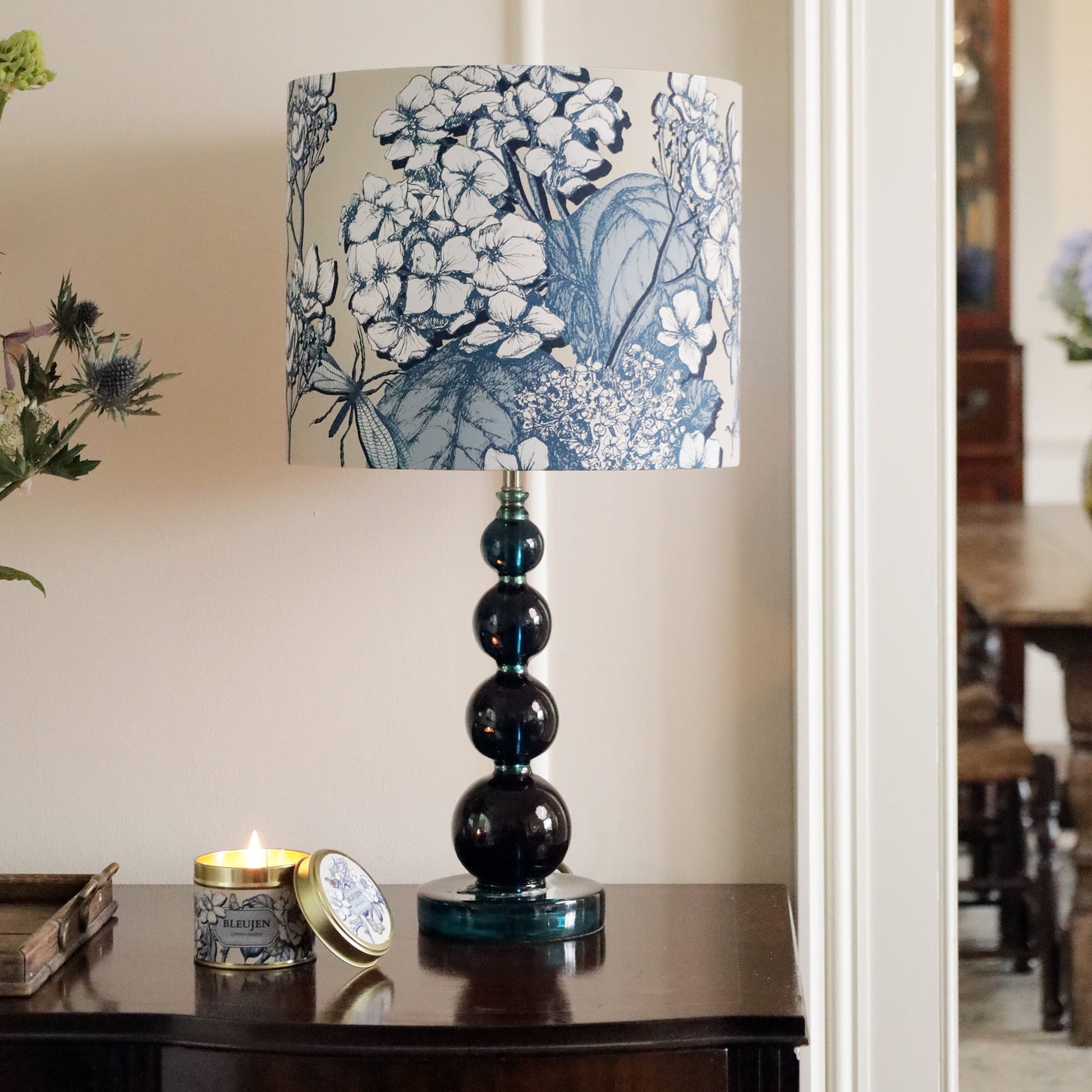 Decorative lamp with hydrangea pattern on a table in a room setting