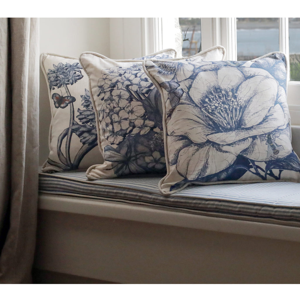Camelia, Hydrangea & agapanthus patterned cushions on a window seat with a neutral background