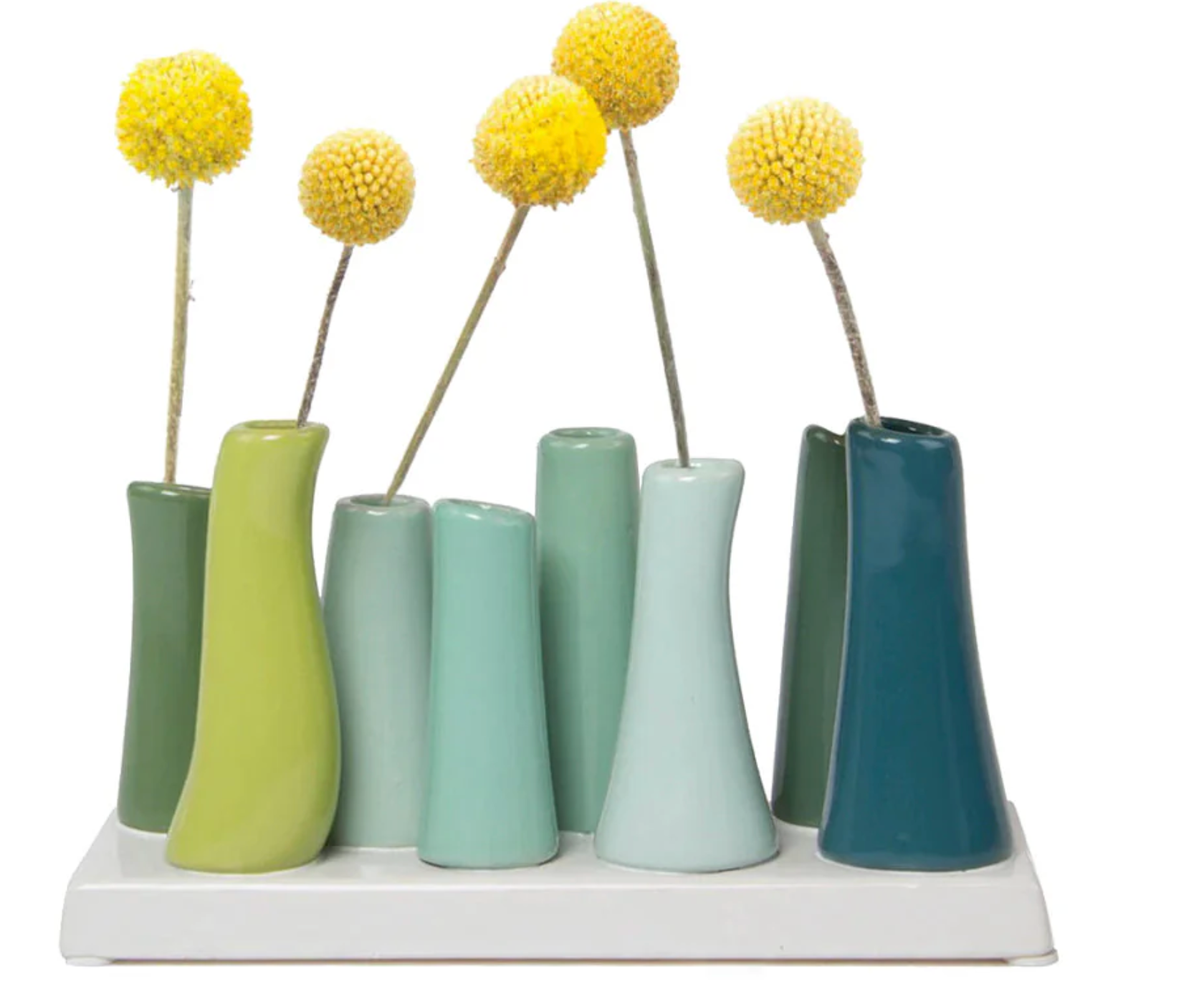 A set of ceramic vases with a glazed finish, displayed in a variety of colorus including green and  blue, arranged in a line on a white surface.
