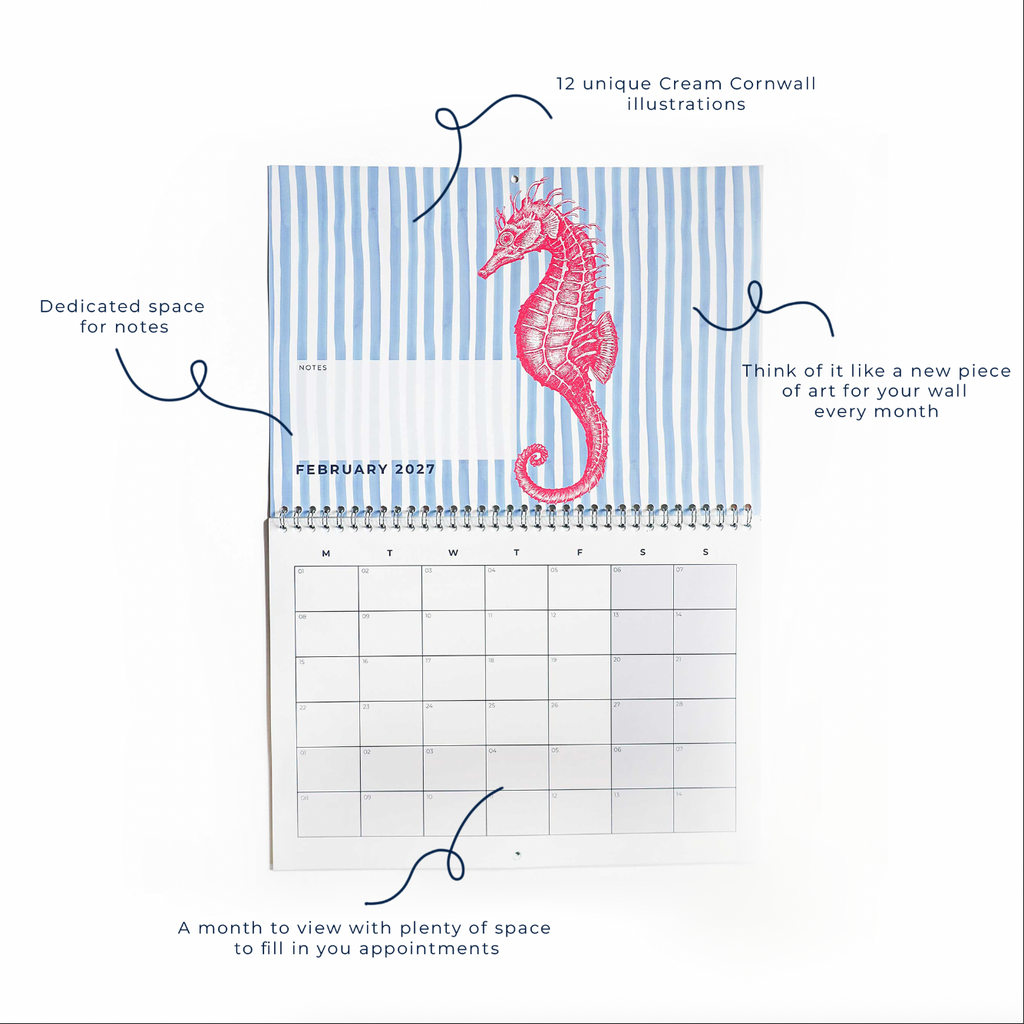 Cream Cornwall 2027 wall calendar open to February, featuring a red seahorse illustration on blue and white stripes, with month-to-view planner, notes section and space for appointments.