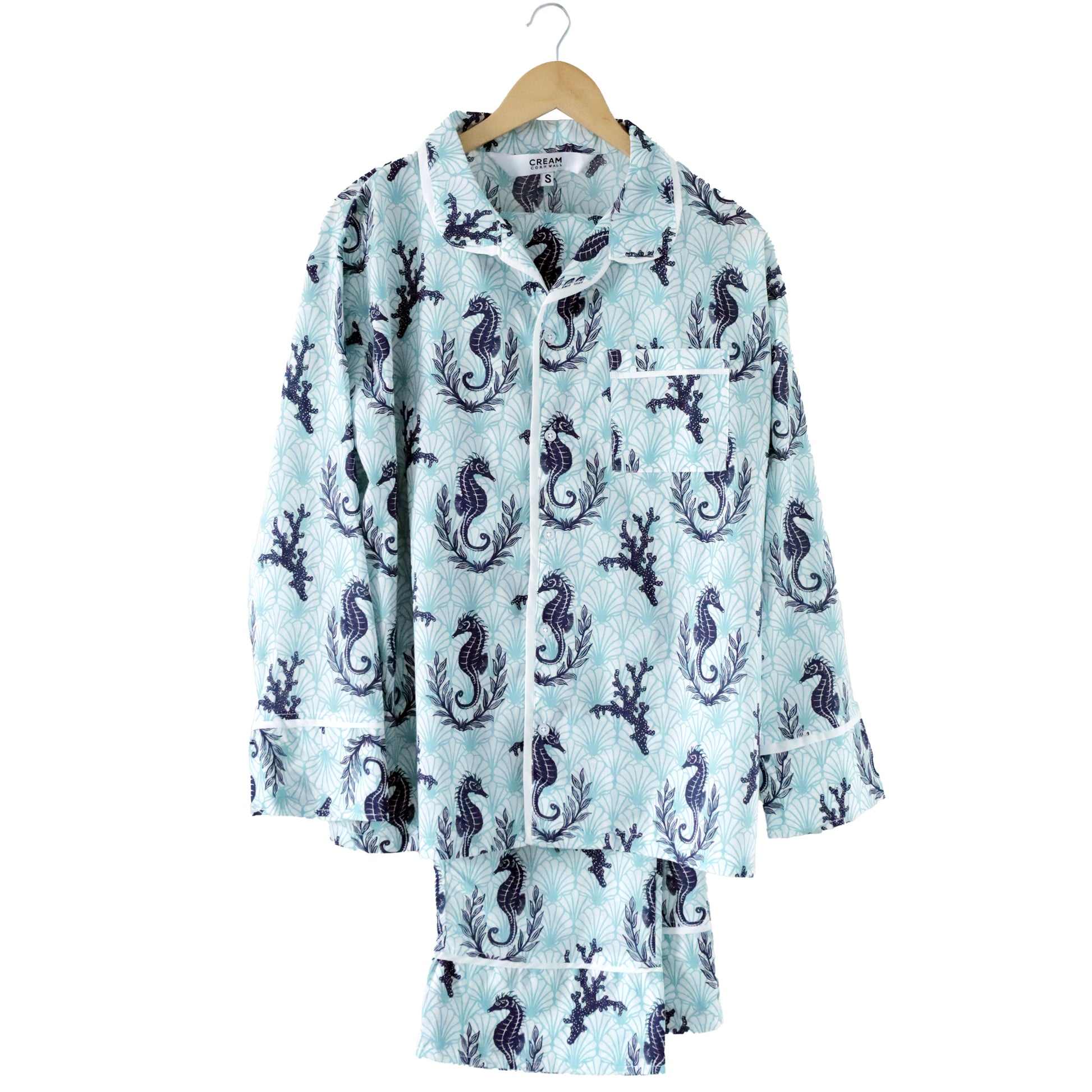 Floral patterned pyjamas on a hanger against a white background