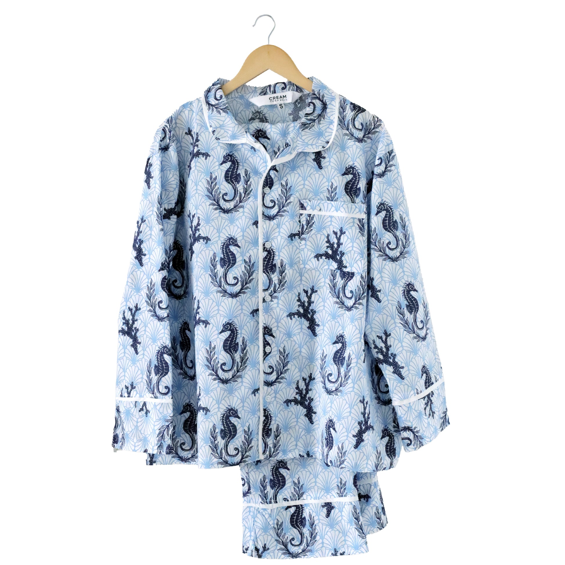 Floral-patterned pyjamas on a hanger with a white background