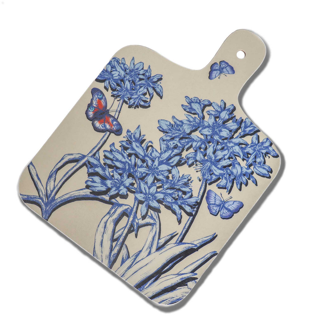 Cream Cornwall Agapanthus serving board featuring intricate blue botanical illustrations of agapanthus flowers and colourful butterflies on a soft cream background, with a rounded handle and hanging hole.