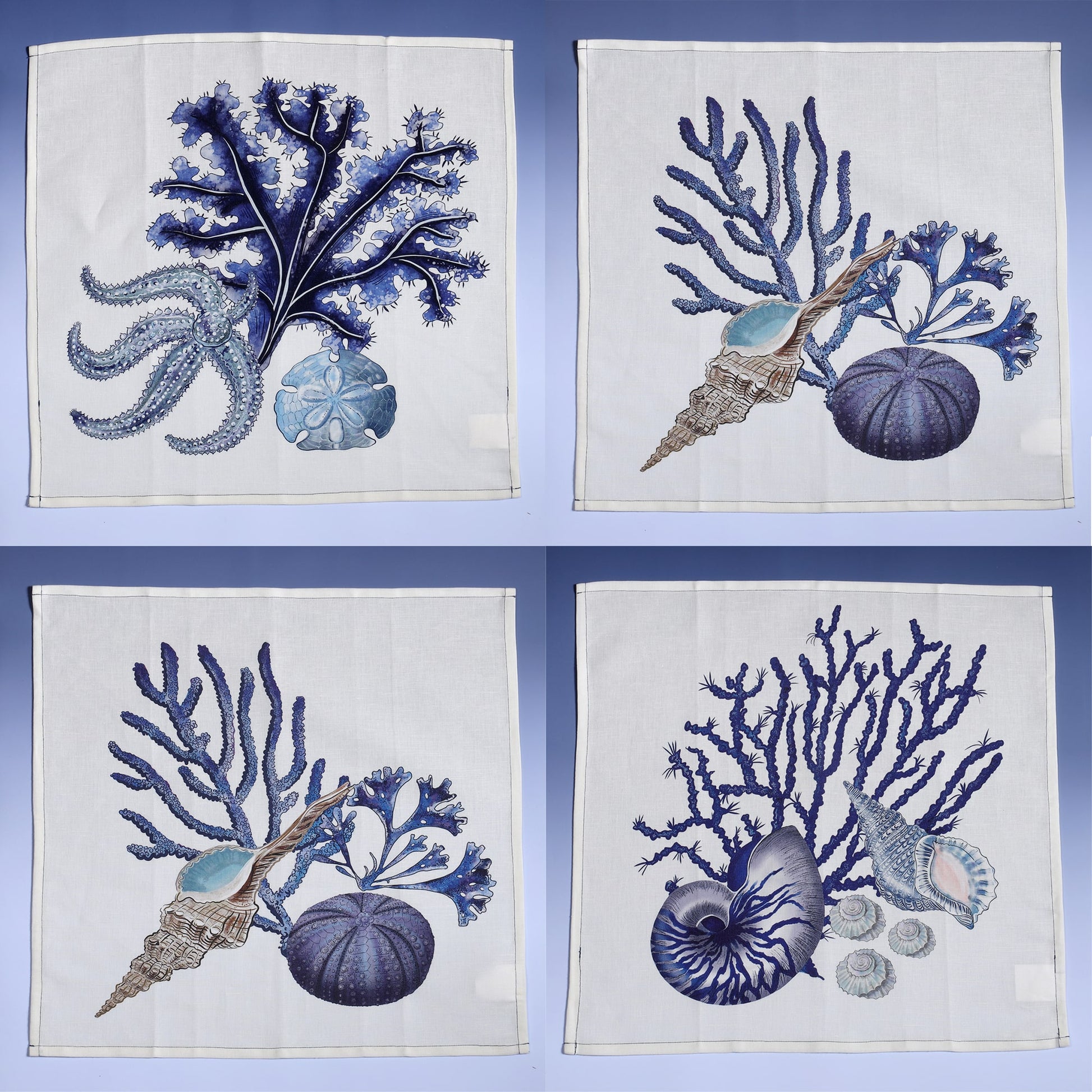 Set of 4 off white linen napkins with hand drawn beachcomber illustrations,set of four different ones displayed in a set of four opened out