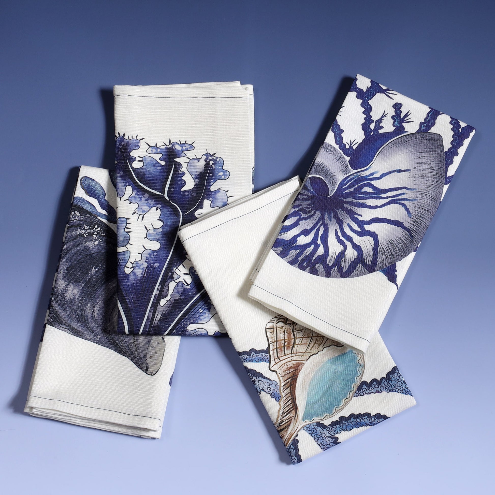 Set of 4 off white linen napkins with hand drawn beachcomber illustrations,set of four different ones folded on top of each other