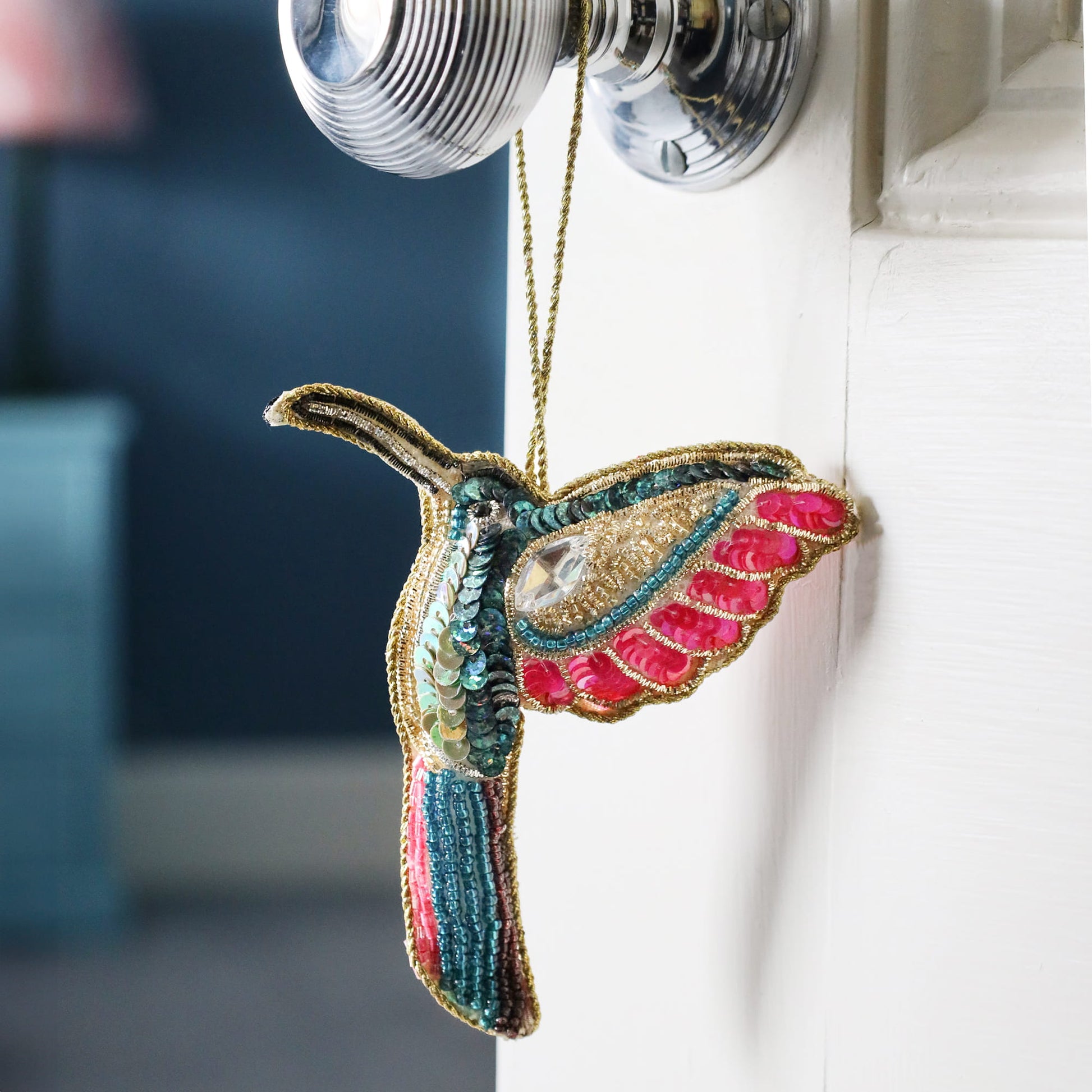 Decorative hummingbird ornament hanging on a radiator
