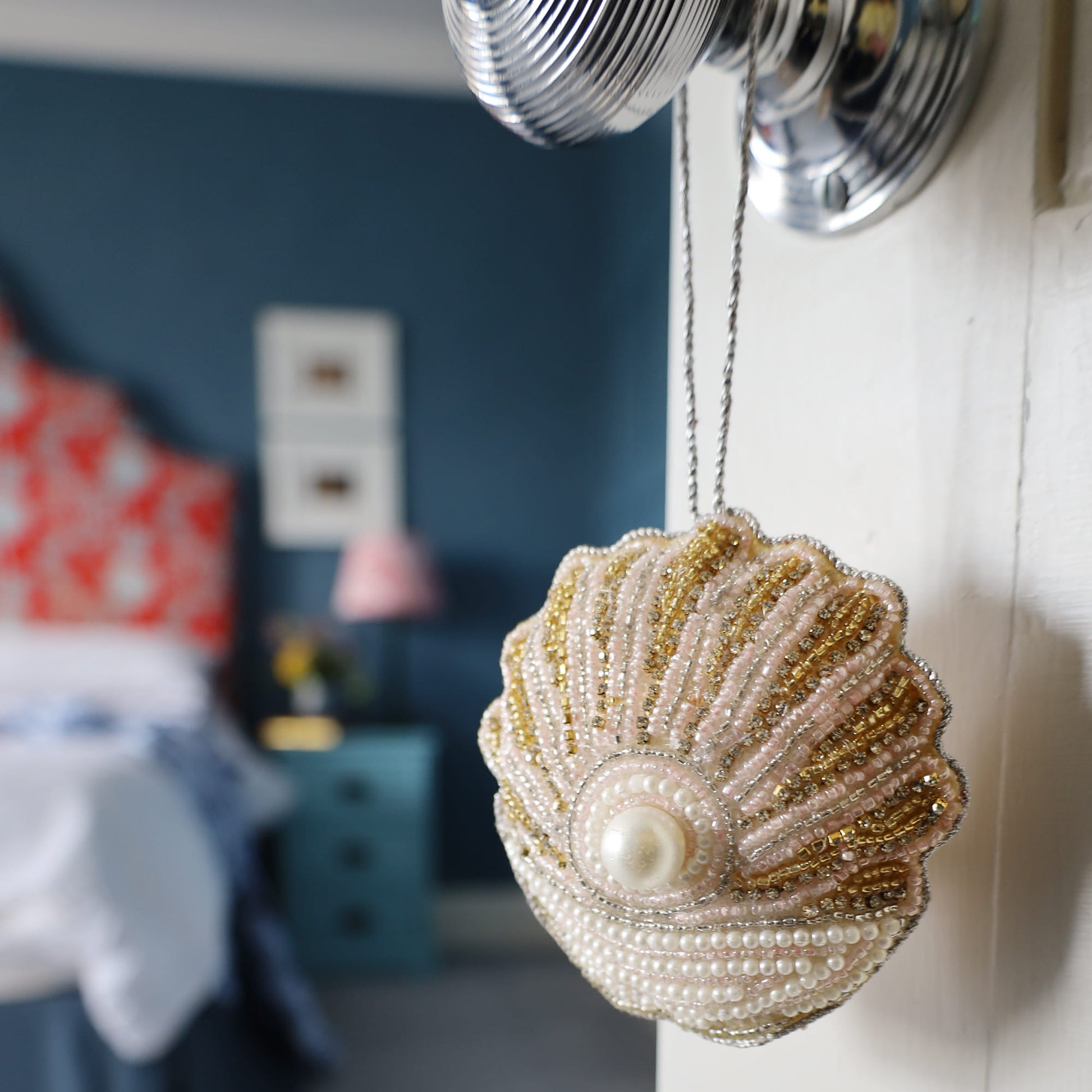Decorative shell ornament with beads and pearl in a room setting