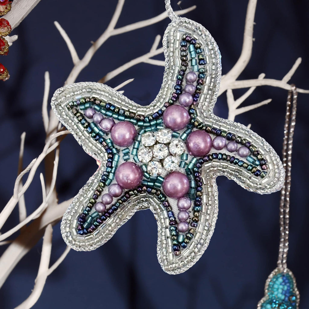 Decorative starfish ornament with beads on a dark background