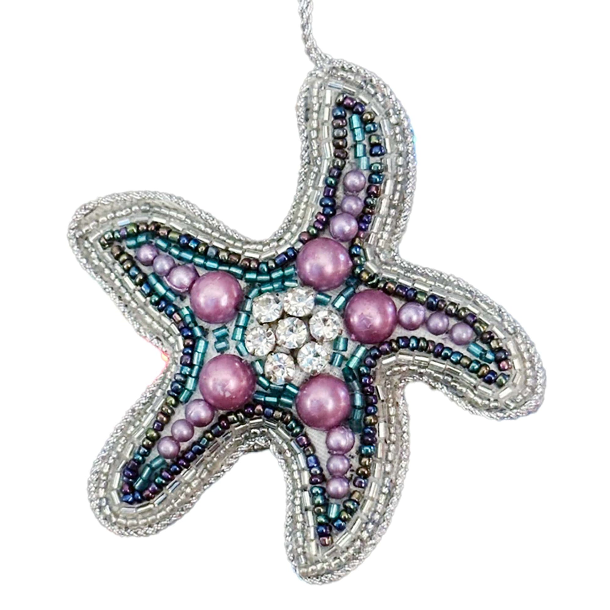Decorative starfish ornament with beads and pearls on a white background