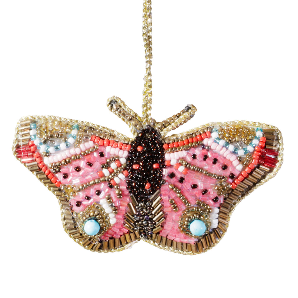 Beaded butterfly ornament with pink wings on a white background