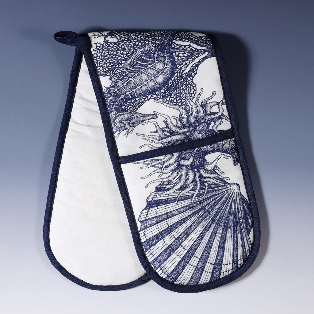 Cotton and linen mix oven gloves with hand drawn illustrations of our classic print of Jellyfish,seahorses,anemones and Octopus design on white with Navy contrasting finish