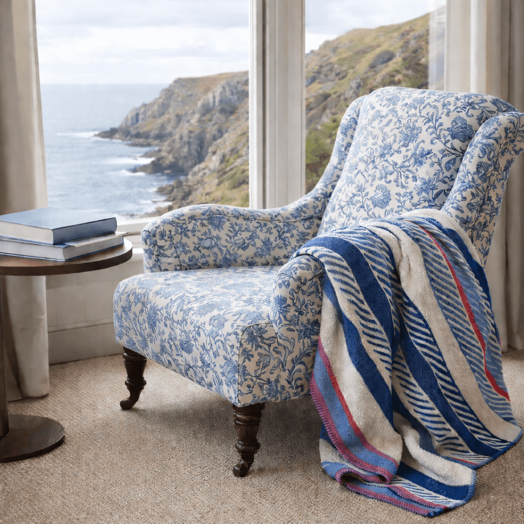 chair covered in cream cornwall sea flower fabric with Mousehole throw draped over the arm