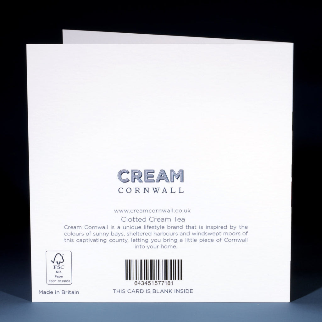 Back of a Cream Cornwall greeting card titled "Clotted Cream Tea," featuring the brand’s logo, website (www.creamcornwall.co.uk), and product description. The description highlights the inspiration behind the brand—Cornwall’s sunny bays, harbours, and moors. Includes a barcode, FSC certification logo, and note stating the card is blank inside.