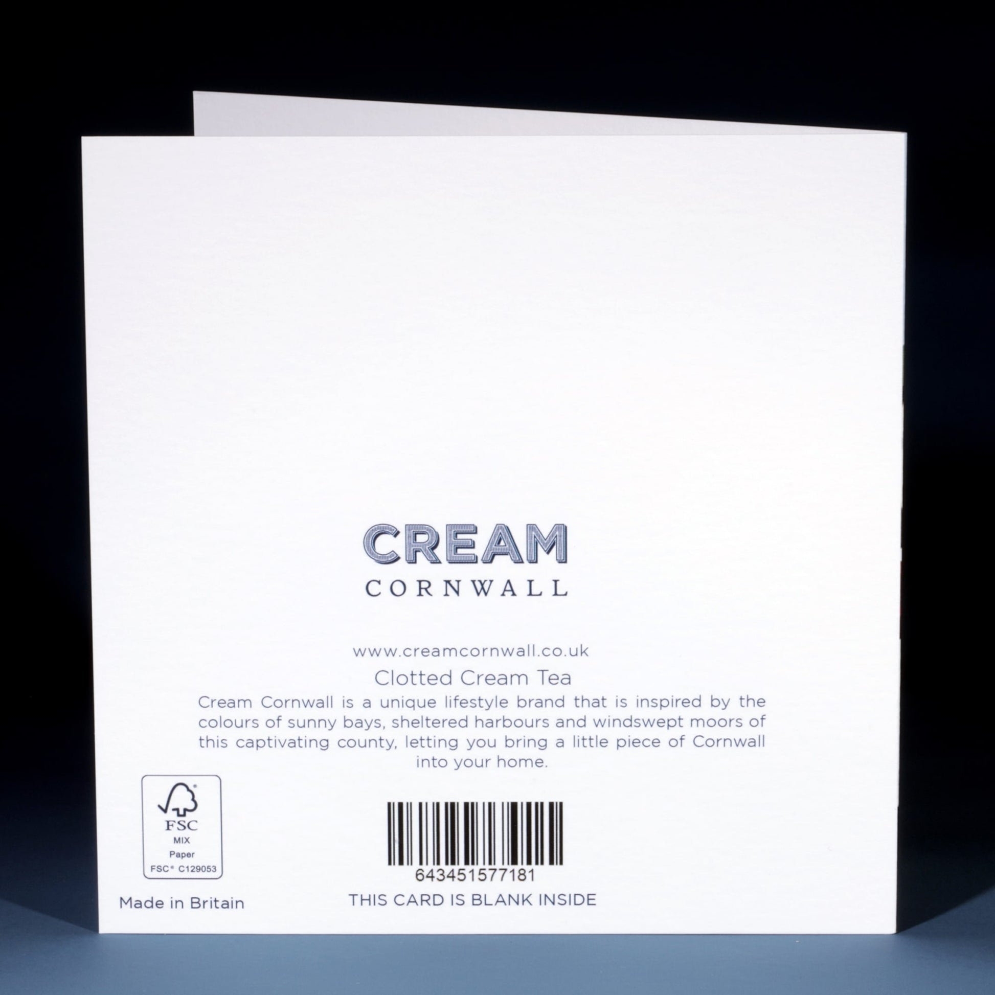 Back of a Cream Cornwall greeting card titled "Clotted Cream Tea," featuring the brand’s logo, website (www.creamcornwall.co.uk), and product description. The description highlights the inspiration behind the brand—Cornwall’s sunny bays, harbours, and moors. Includes a barcode, FSC certification logo, and note stating the card is blank inside.