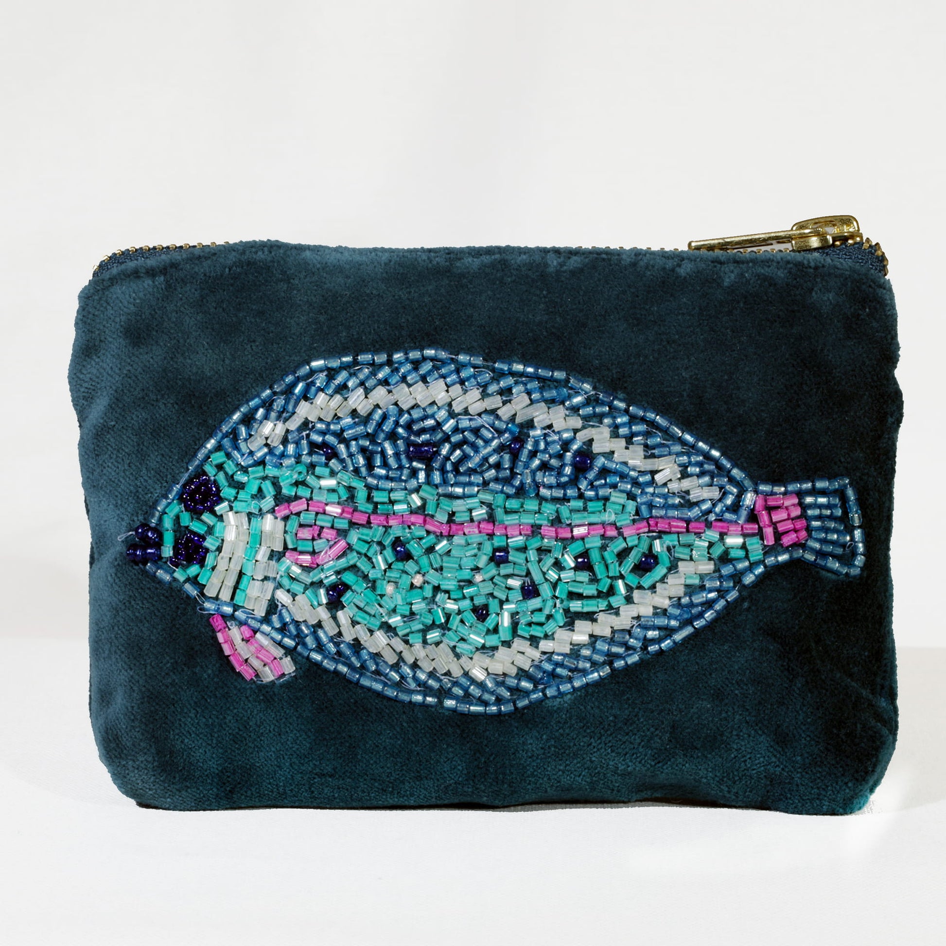 Teal pouch with a fish design made of beads on a white background