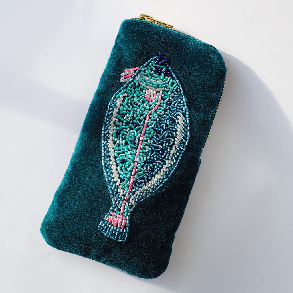 Teal glasses case with  beaded fish on a white background