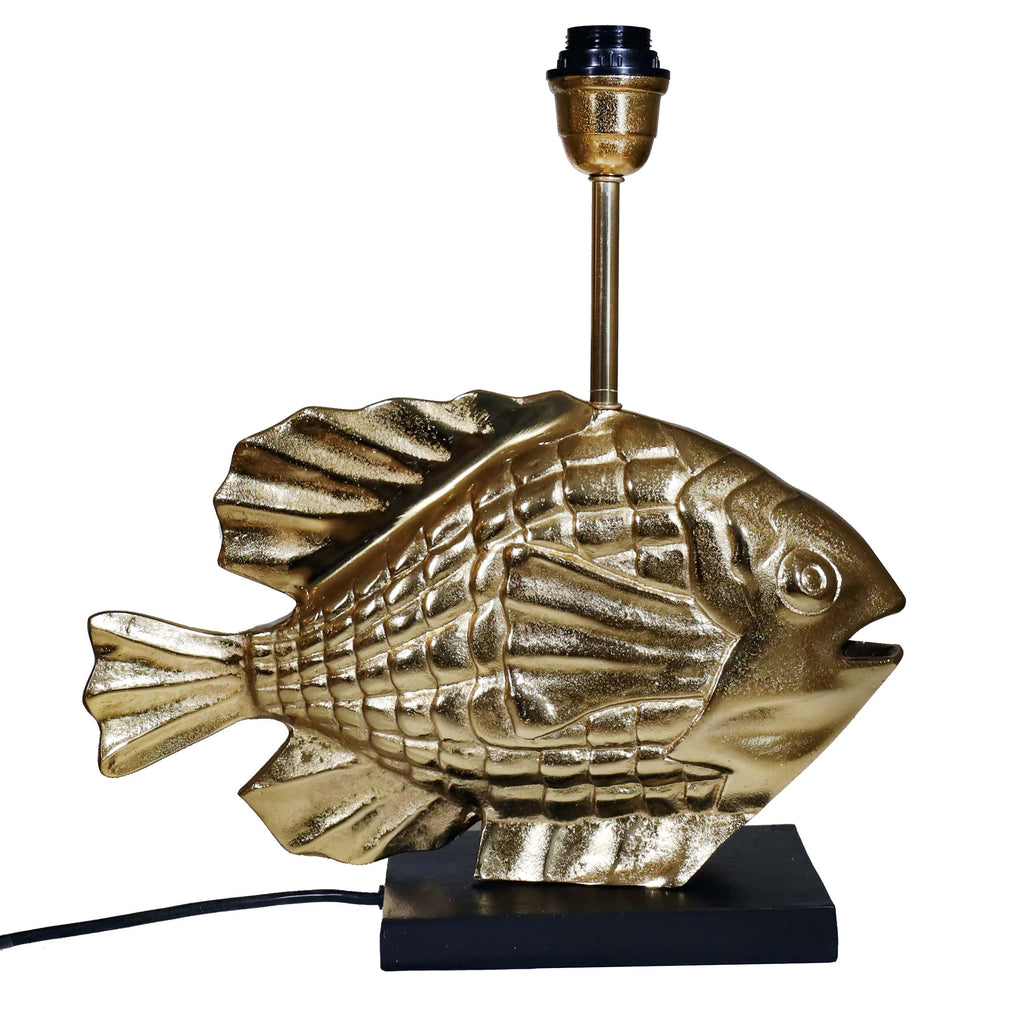 A gold fish-shaped lamp base featuring textured scales and fins, mounted on a rectangular black base with a black lamp fitting and visible black cord.