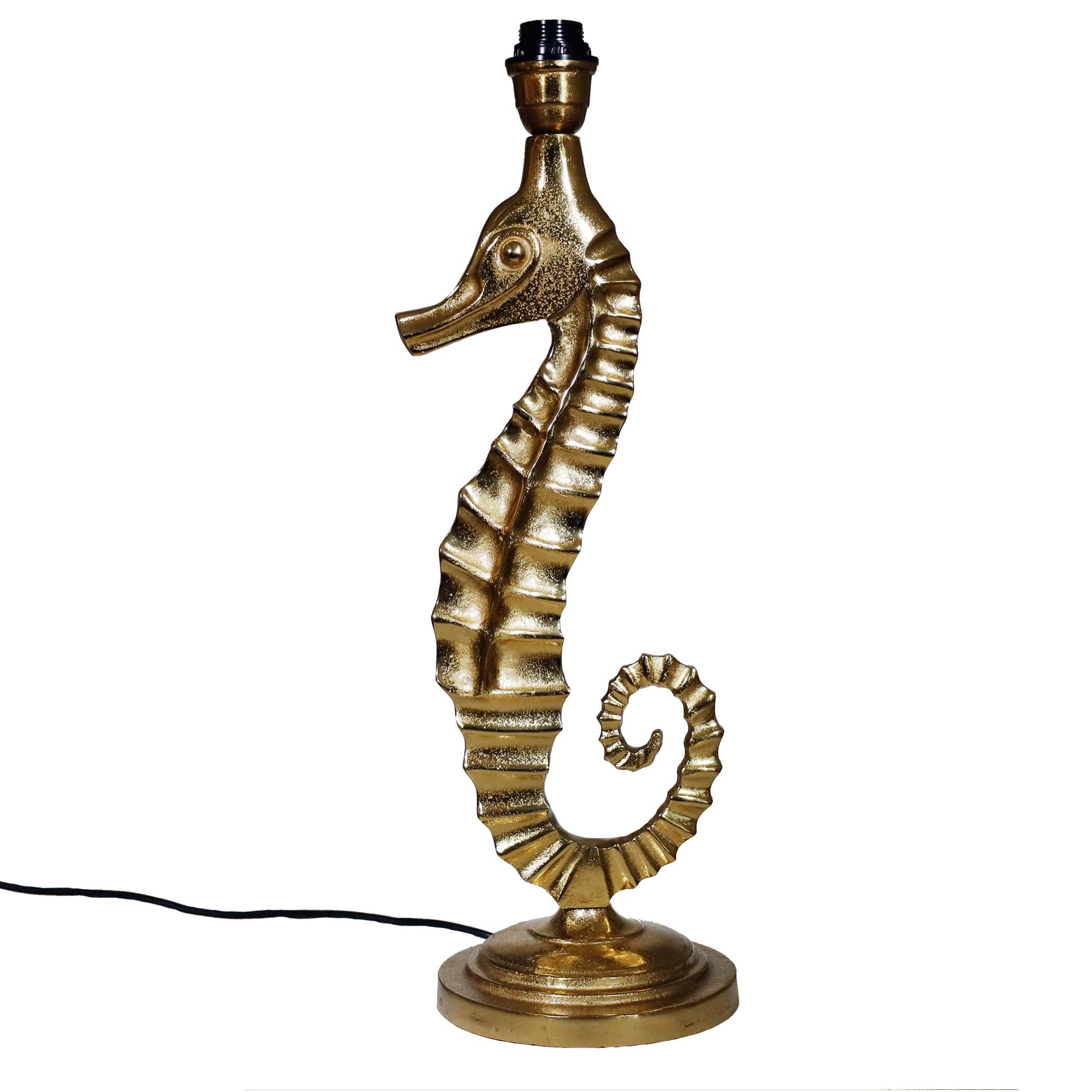 A gold seahorse-shaped lamp base with a coiled tail and textured detailing, standing on a round pedestal with a visible black cord attached.
