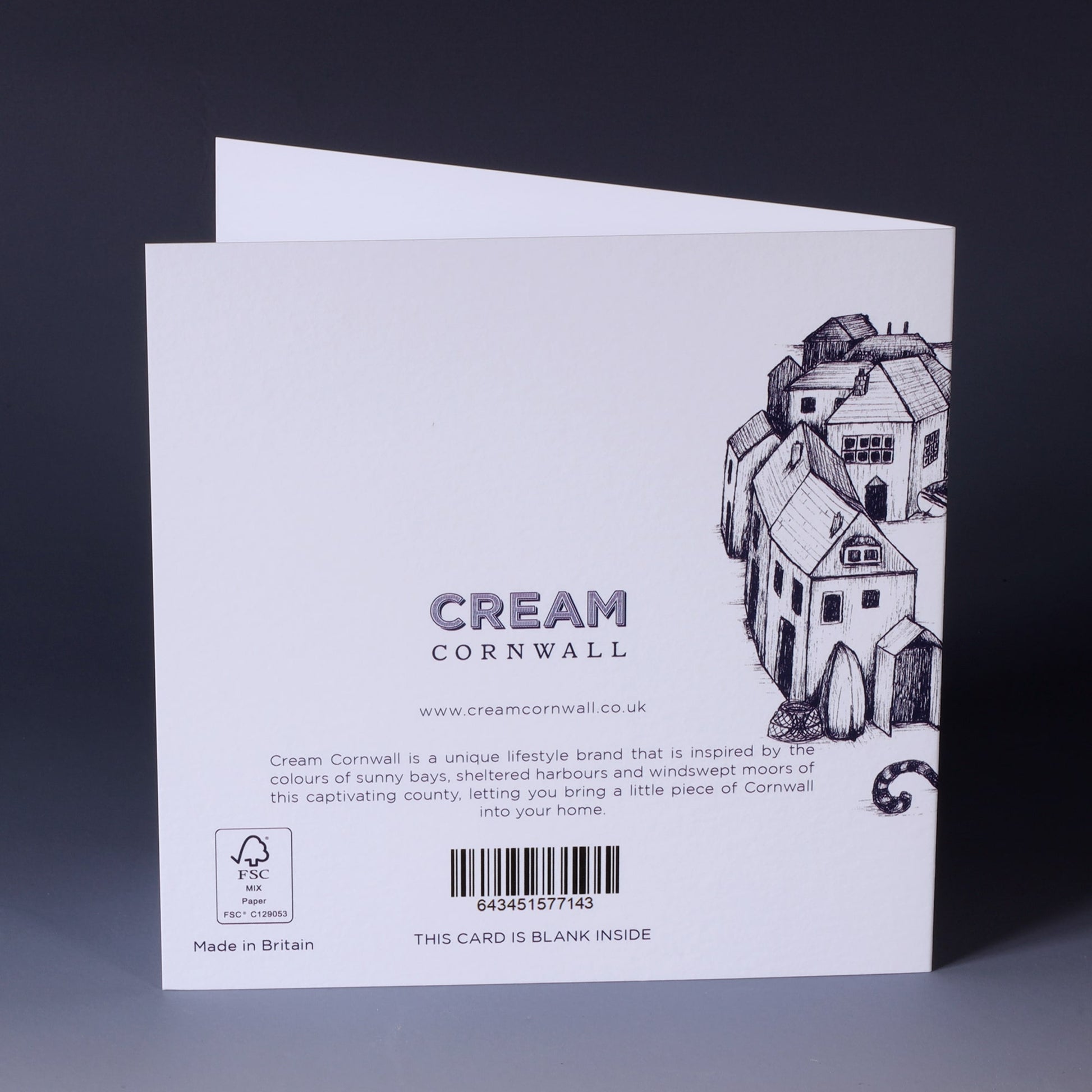 back of greeting card with navy illustration of cornish harbour scene on a white background