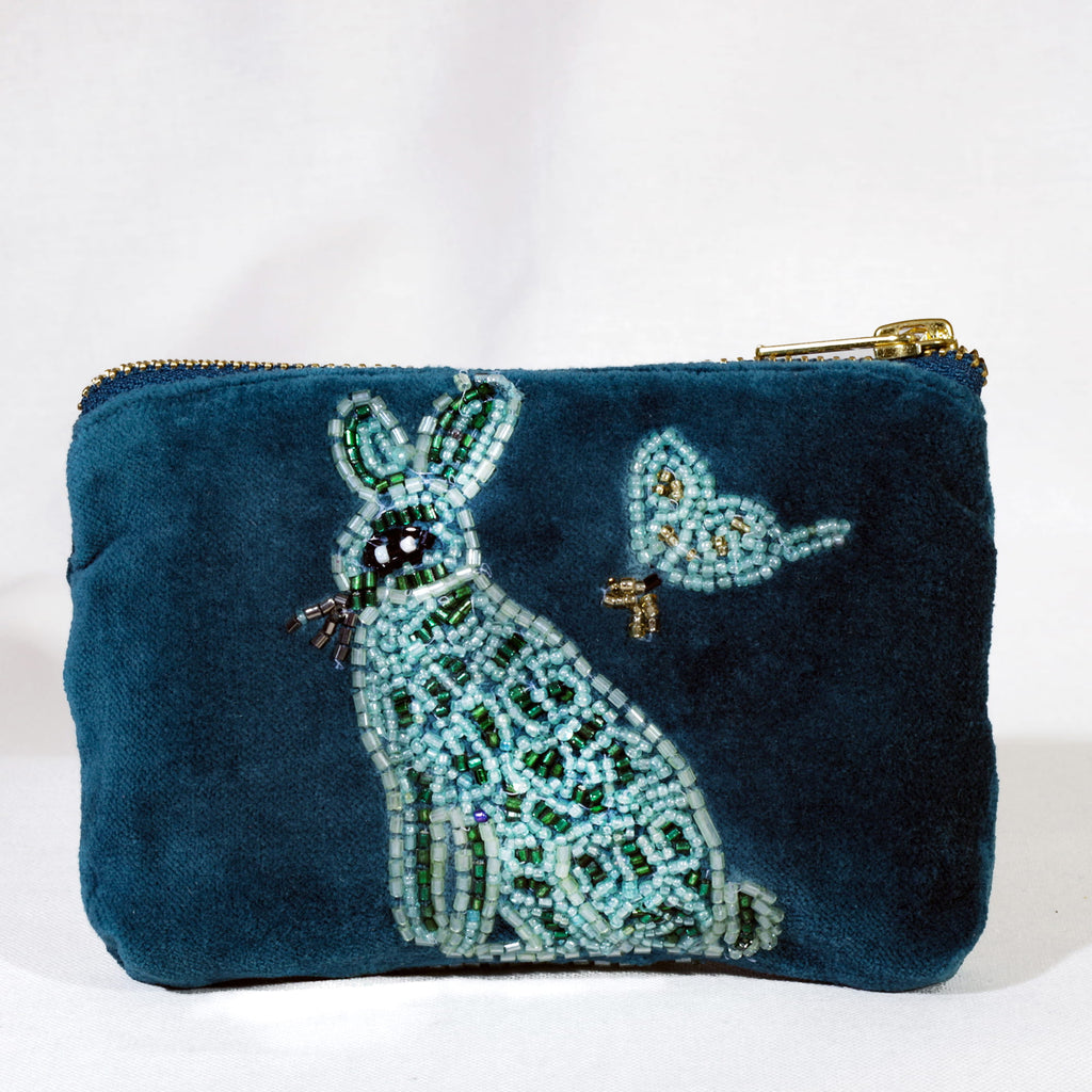 Teal pouch with embroidered hare and butterfly design on a white background