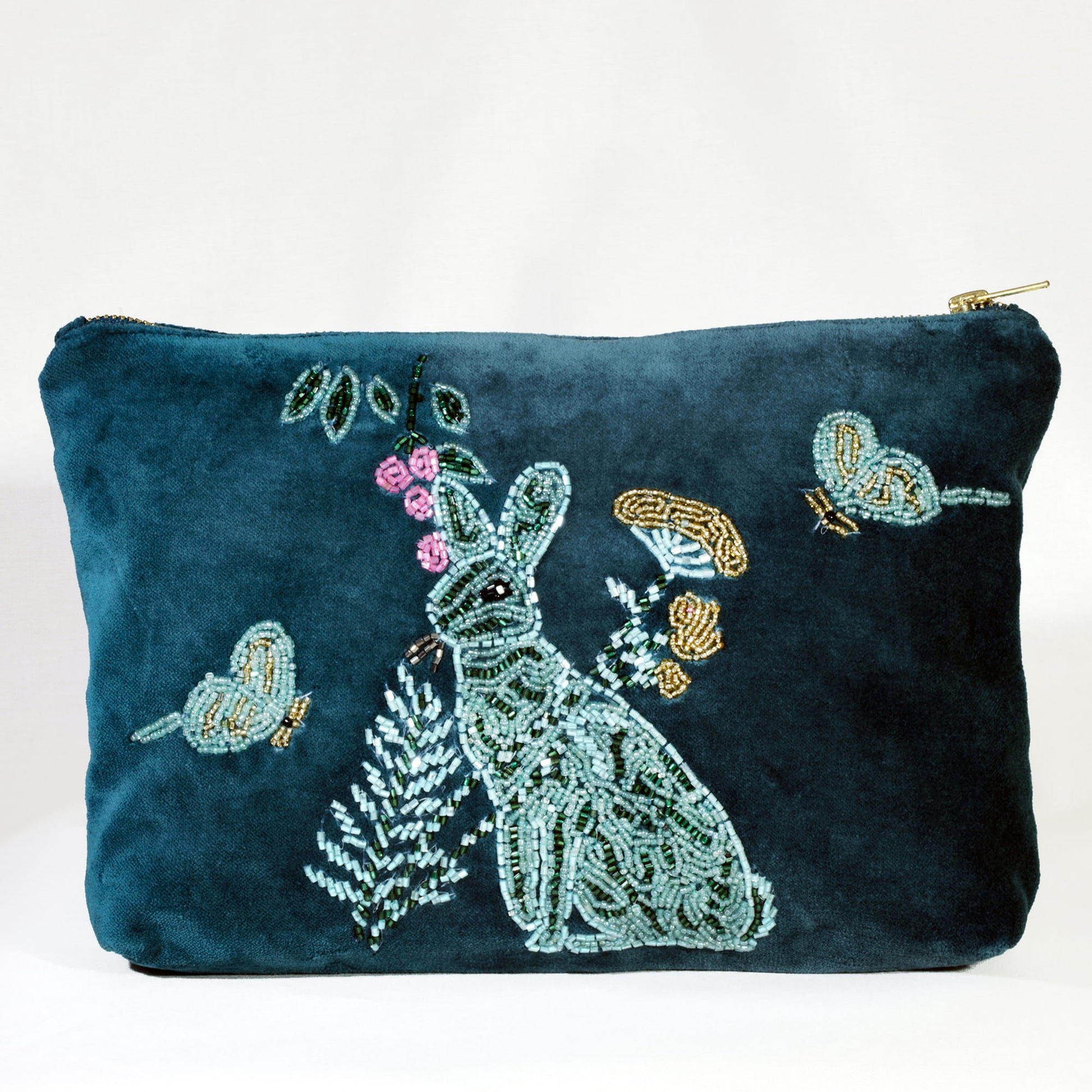 Teal pouch with beaded design of a hare, flowers, and birds on a white background
