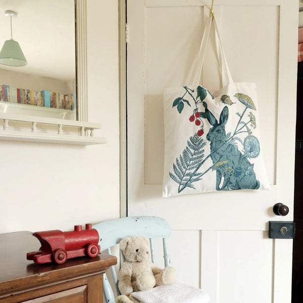Colourful hare cotton tote bag hanging on back of door