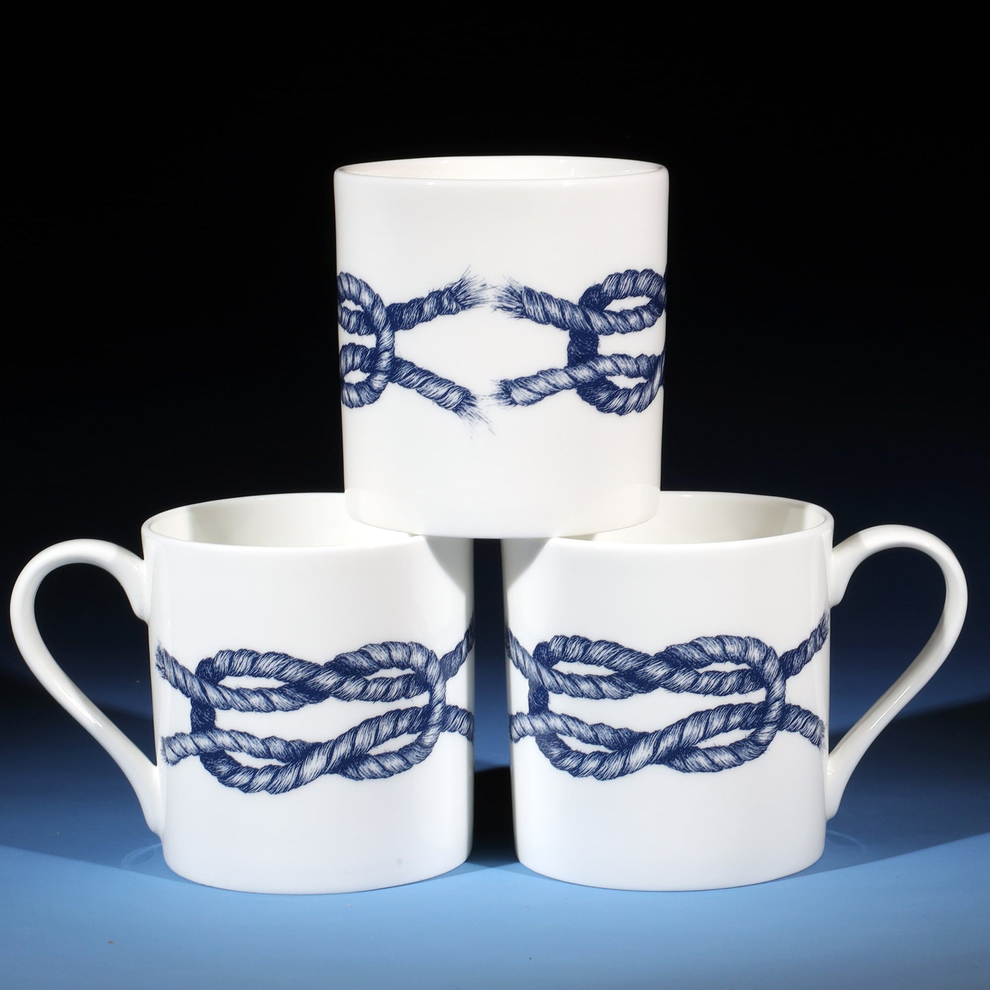 Stack of three Reef Knot mugs showing all sides of the mug.