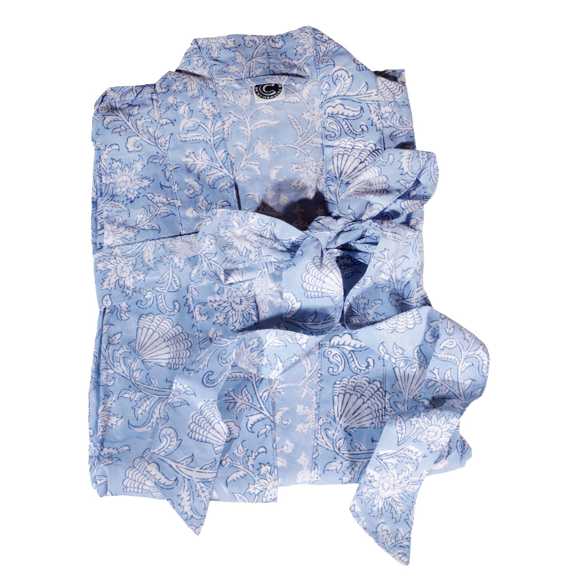 Light blue dressing gown featuring intricate white floral and seashell block print patterns. The soft fabric is folded neatly, showcasing its elegant and timeless design.