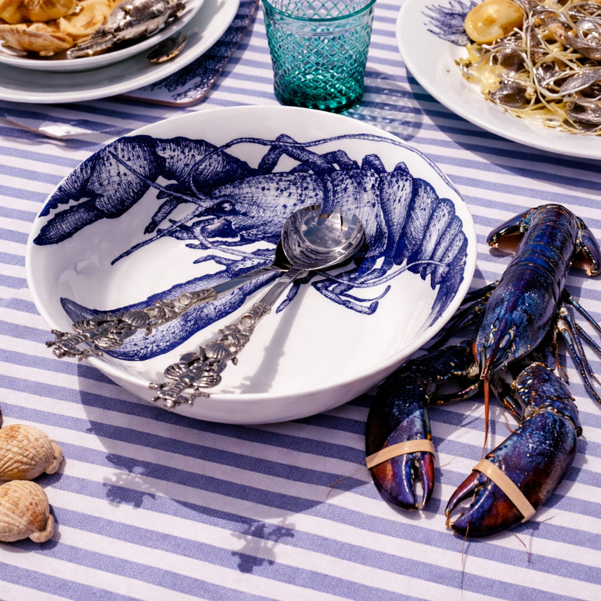 Seafood dish with lobsters on a striped tablecloth