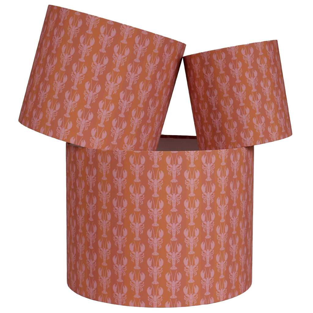 Drum lampshades with pink & orange mini lobster pattern on a white background