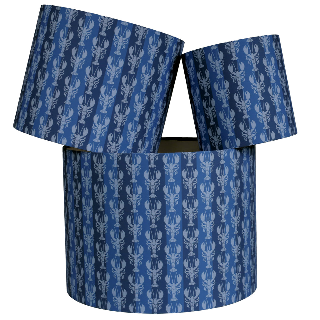 Blue cylindrical lampshade with lobster pattern on a white background