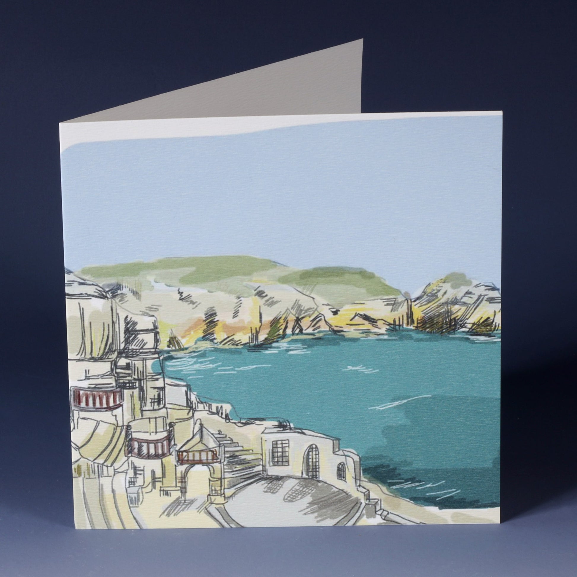 greeting card with illustration of the minnack theatre with the sea inf ront of it and the coastline running alongside 