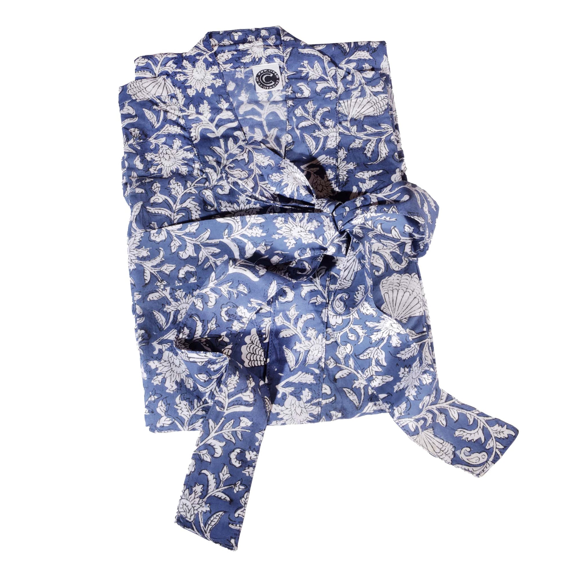 A neatly folded navy blue dressing gown featuring intricate white block-printed floral and shell patterns, tied securely with a matching fabric belt. The gown showcases elegant craftsmanship and a timeless design.