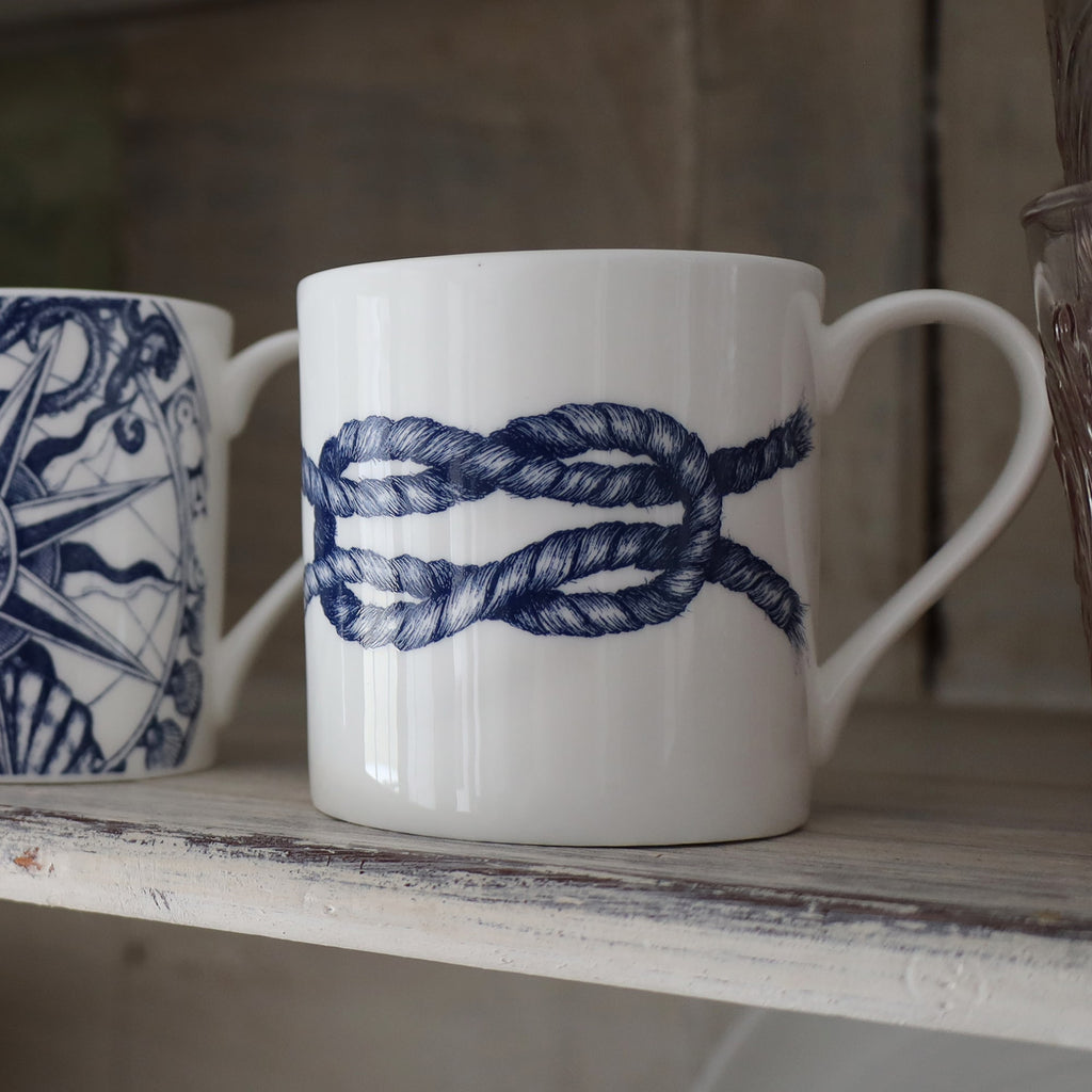 Reef Knot mug on a whitewashed shelf.