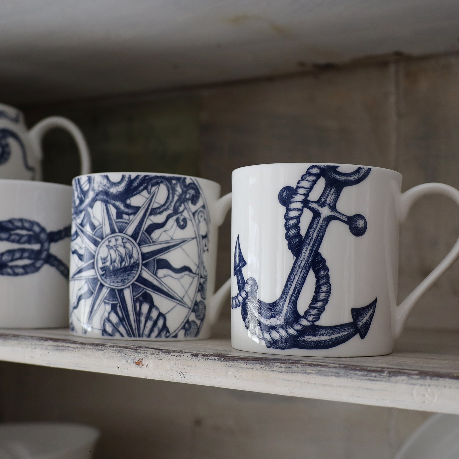 Anchor with a twisted Rope,Reef Knot and Compass Mug on a whitewashed shelf