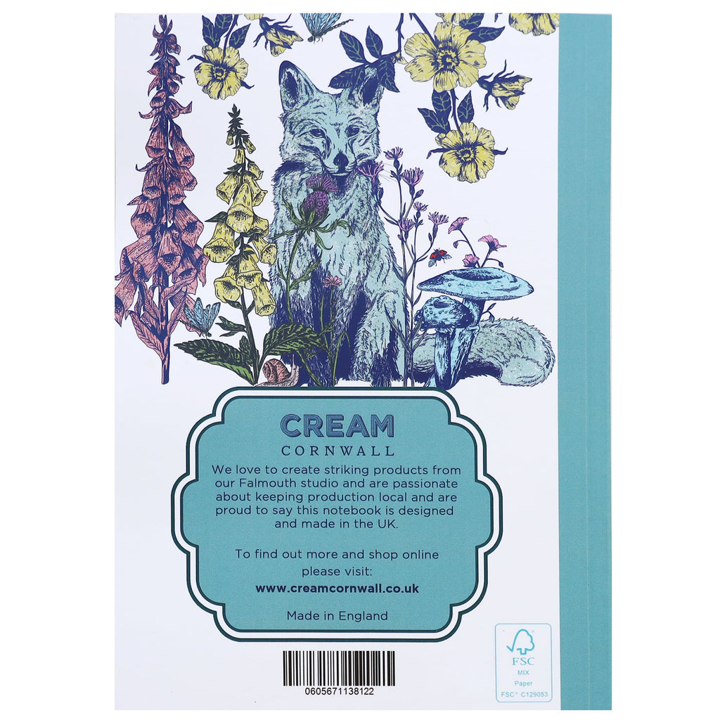 Back cover of a notebook featuring an illustrated fox surrounded by wildflowers, mushrooms, and foliage, with product information from Cream Cornwall printed in a teal label at the bottom.