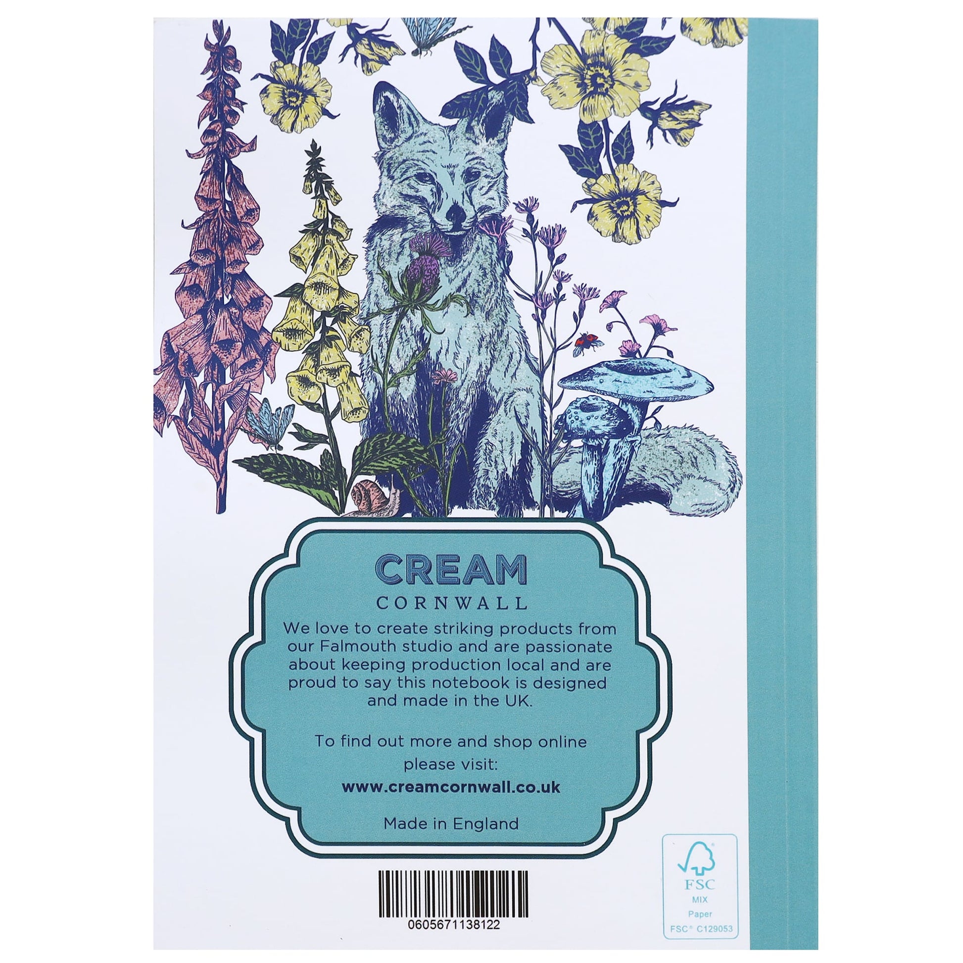 Back cover of a notebook featuring an illustrated fox surrounded by wildflowers, mushrooms, and foliage, with product information from Cream Cornwall printed in a teal label at the bottom.