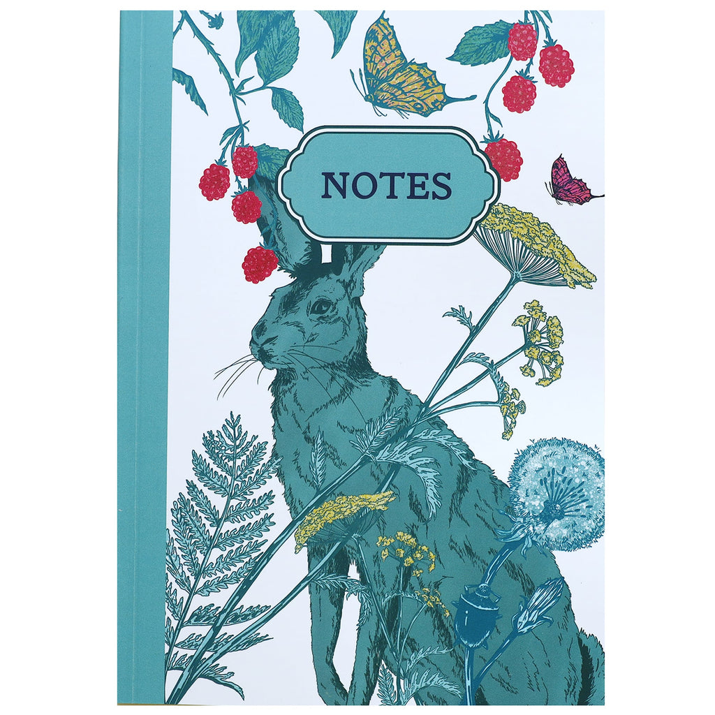 Illustrated notebook cover featuring a teal hare surrounded by botanical elements like dandelions, cow parsley, and wildflowers. Raspberries and butterflies frame a decorative label that reads "NOTES" at the top center. The background is white with a teal spine.