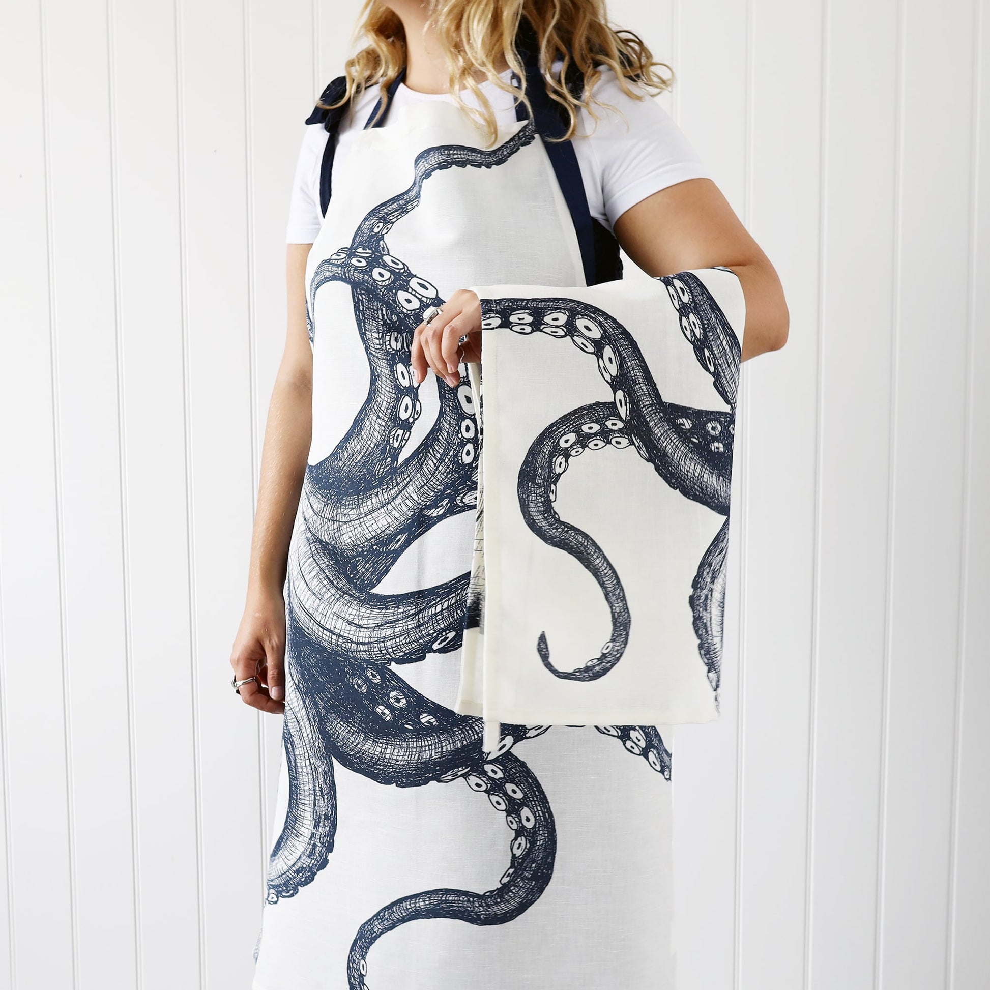 Model wearing our Octopus Aprion with a matching tea towel over her arm