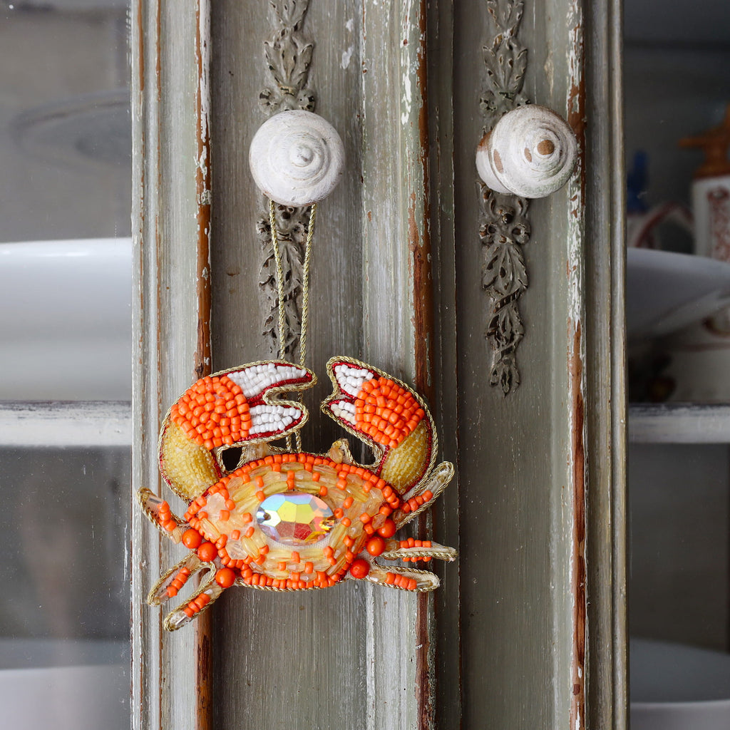 Decorative crab ornament on a textured surface