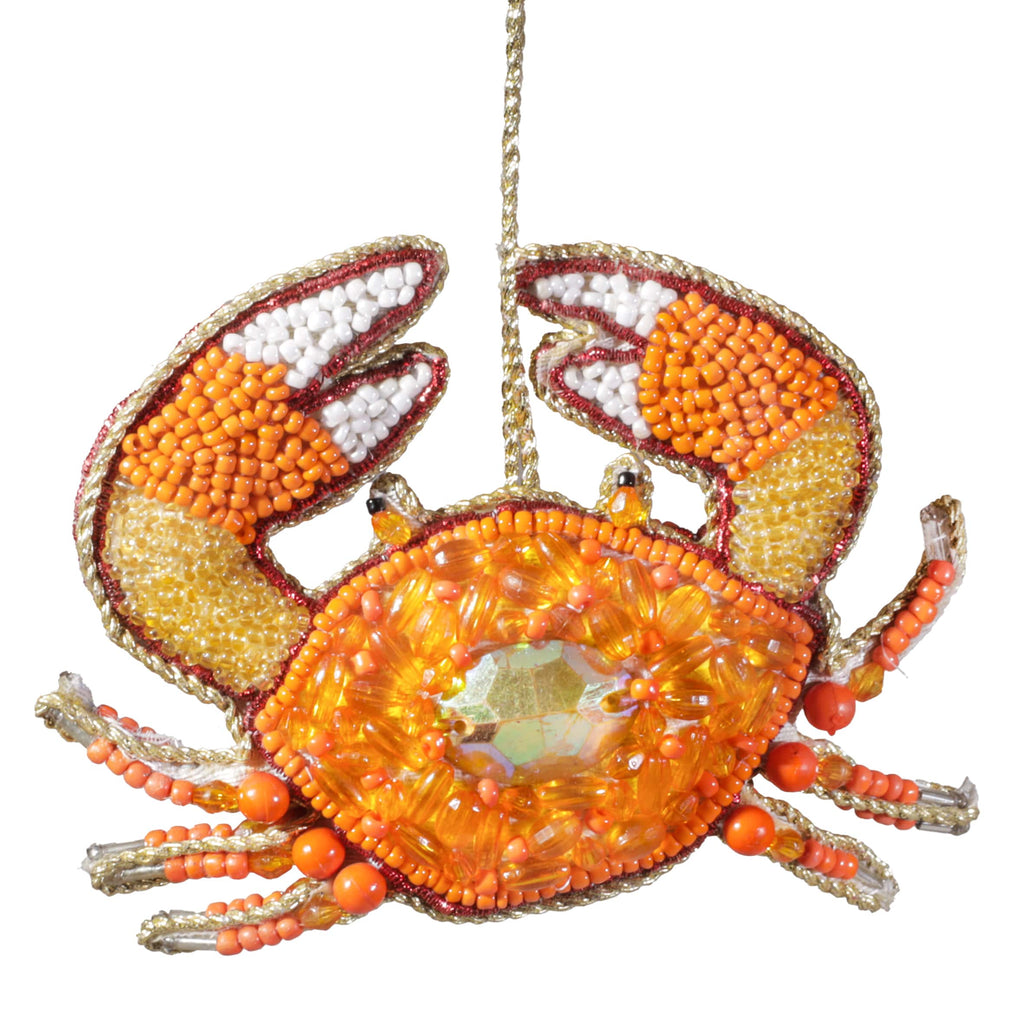 Decorative crab ornament with beads on a white background