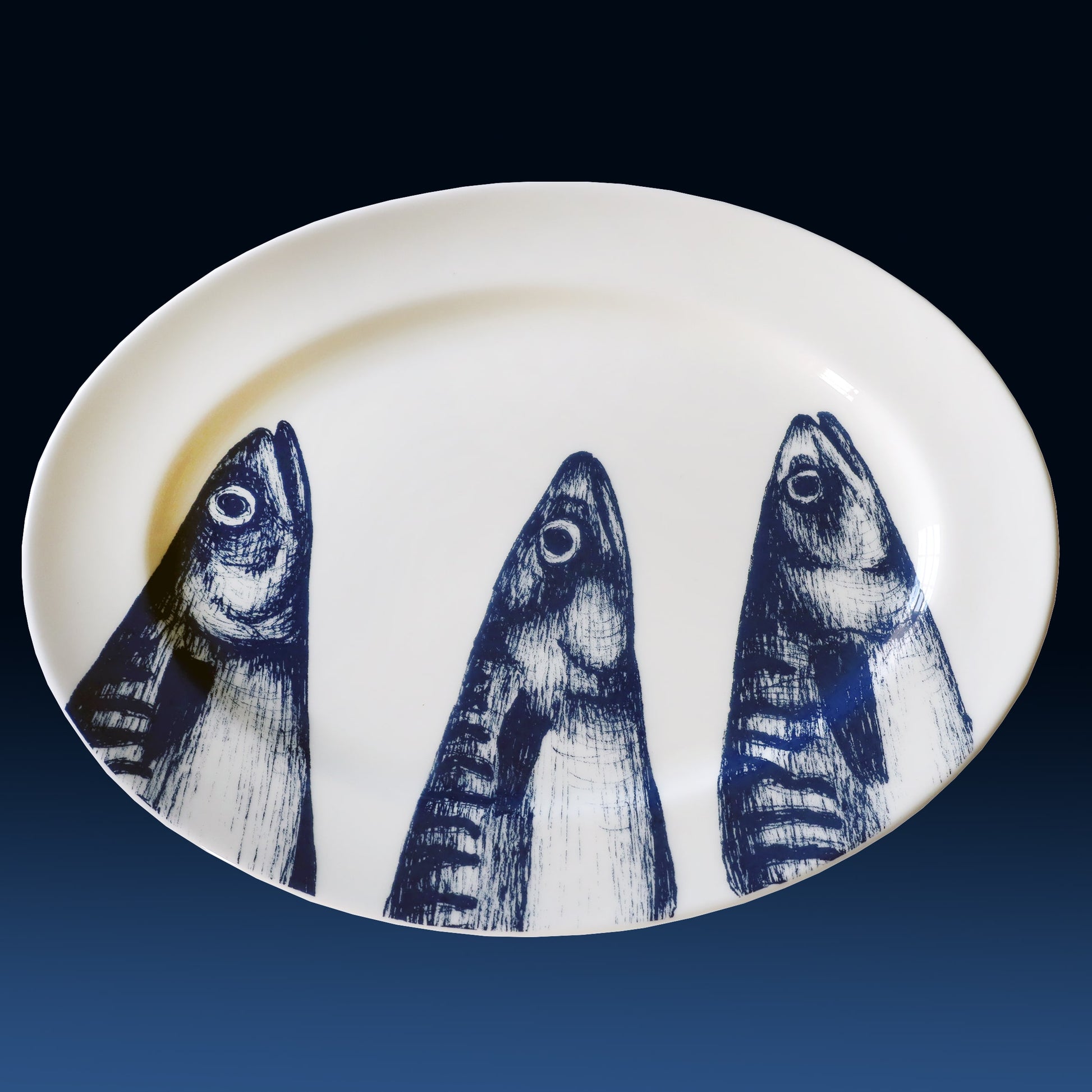 White plate with blue fish illustrations on a gradient background